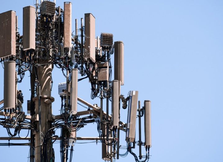 Close-up of a 5G telecoms tower against a blue sky background.