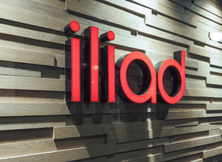 The red Iliad logo on a wall in an office building.