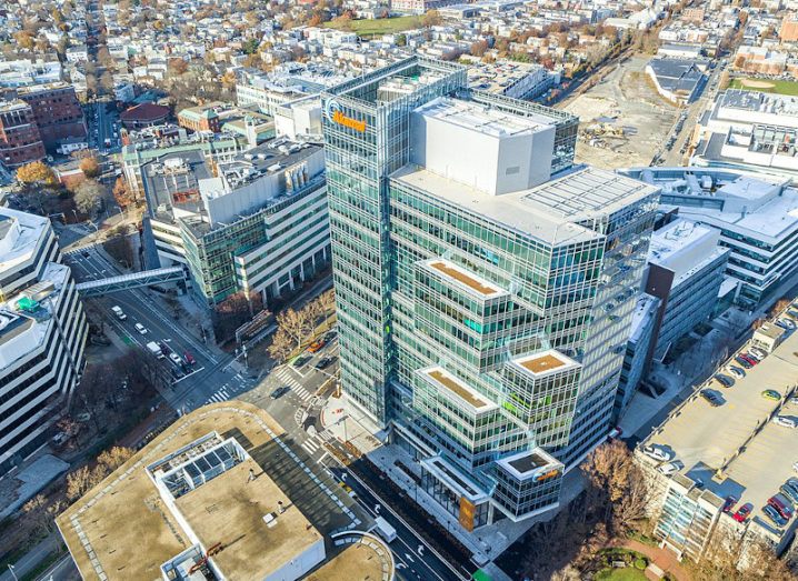 Aerial view of a tall glass building in a city.