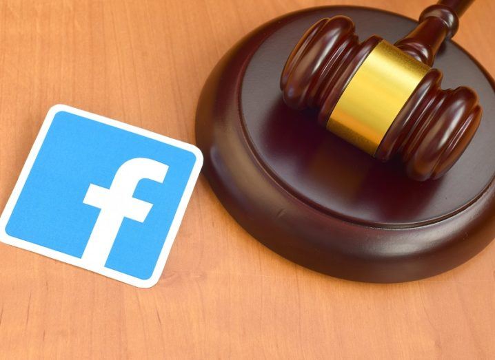 The Facebook logo beside a wooden gavel.