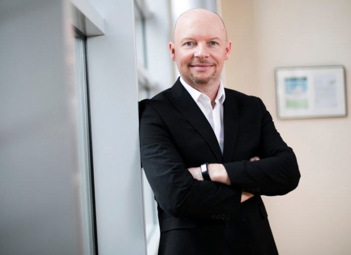 Xilinx MD Brendan Farley is standing against a window with his arms folded.