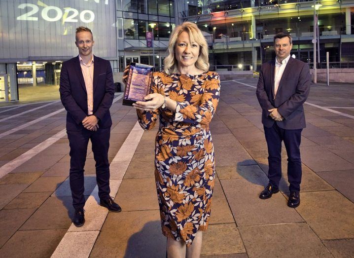 Bridgeen Callan holding her award with Niall Devlin and Steve Or standing behind her.