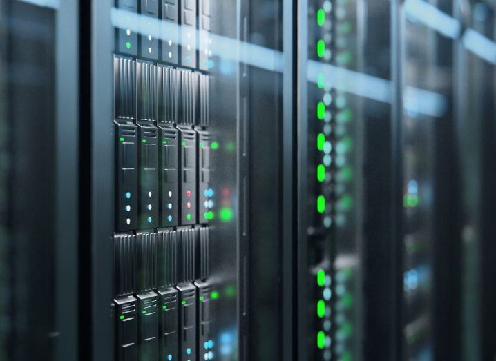 Close-up of a server rack dotted with green lights.