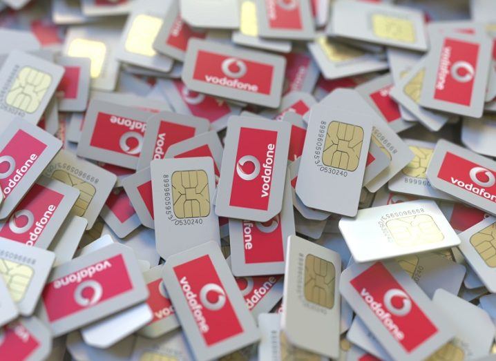 Pile of SIM cards with Vodafone logos on them.