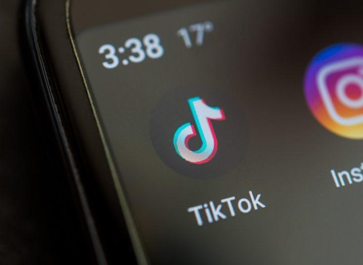 The TikTok logo on a smartphone.