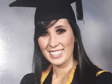 Aoife Skelly, who completed the Leap programme at Fidelity Investments, is smiling into the camera in a graduation hat and robes.