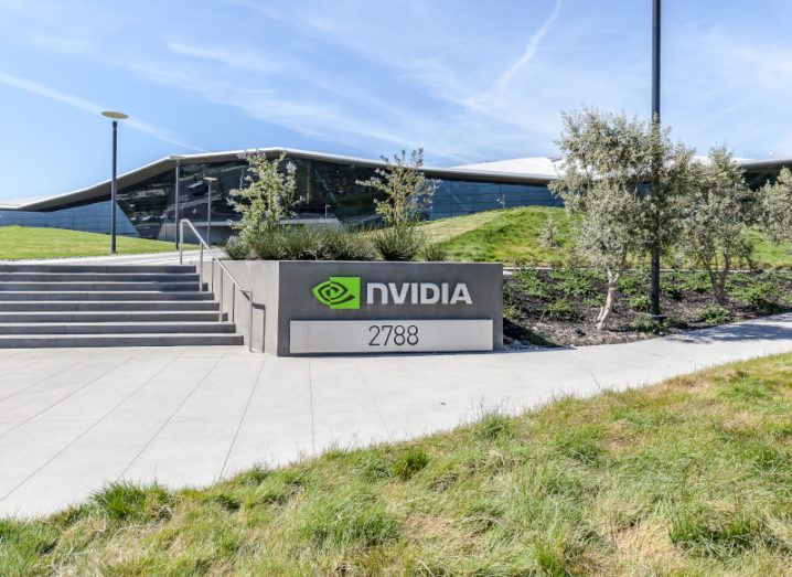 Nvidia headquarters in Silicon Valley on a sunny day. A sign with the green Nvidia logo is at the front of some steps.