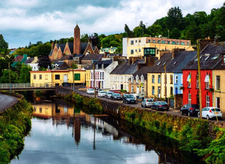 A town landscape in Donegal, with a river and colourful buildings.