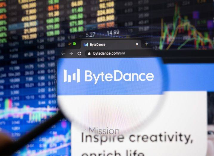 A magnifying glass is highlighting the ByteDance logo on a webpage, against a stock-market background.