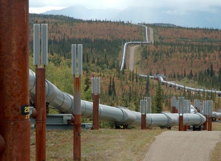 An oil pipeline running across a hilly landscape in the US.