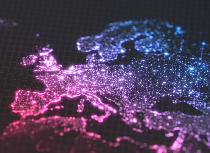 A pink and blue map of Europe with cities populated areas lit up in bright lights.