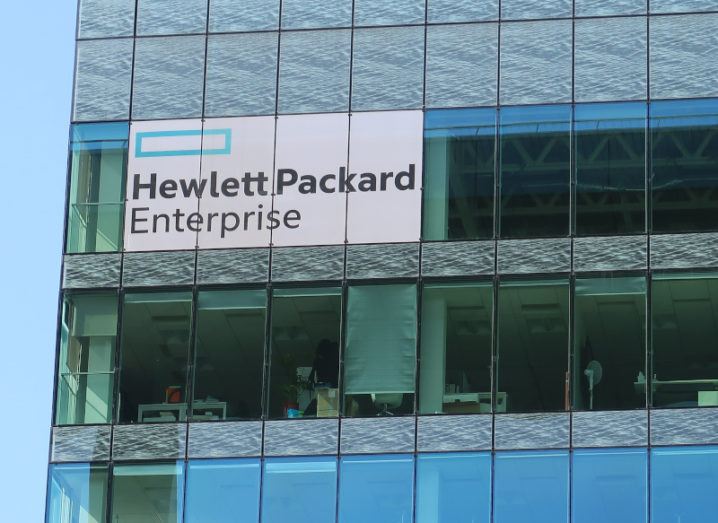 The HPE logo on the side of a large glass building.