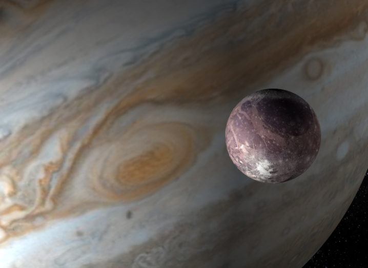 3D image of Ganymede with Jupiter in the background.