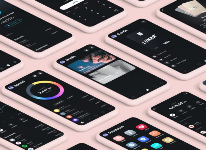 A series of smartphones demonstrating use of the Lunar banking app, laid out neatly on a blush pink surface.