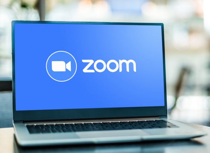 A laptop displaying the Zoom logo.