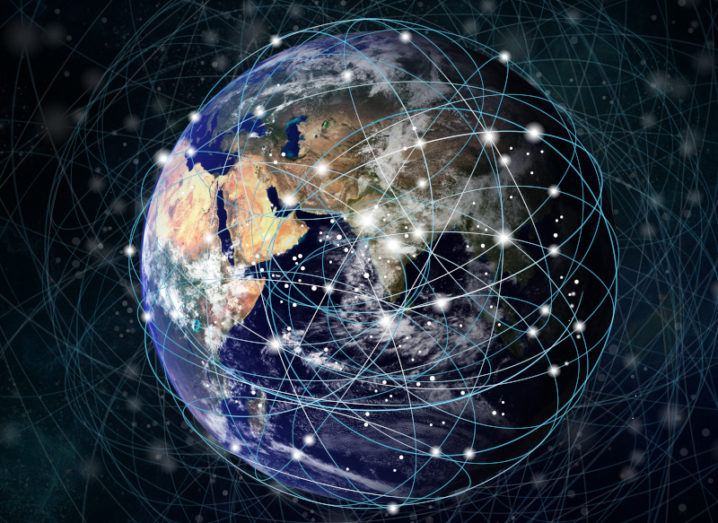 An illustration of the Earth showing numerous criss-crossing satellite orbits, like the Starlink system.