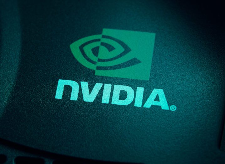 Tech company Nvidia logo bright green lit up against dark background.