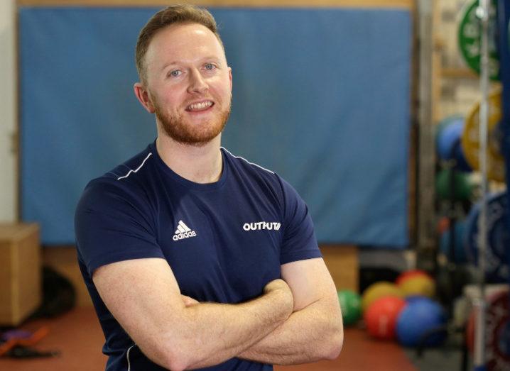 Photo of CEO Dr Martin O'Reilly standing in a gym with his arms folded.