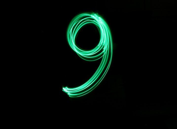 The green flourish of a long exposure light in the shape of the number nine.