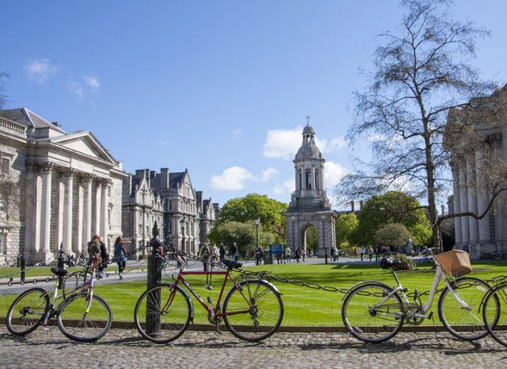 Bikes and students on the campus of Trinity College Dublin on a sunny day.