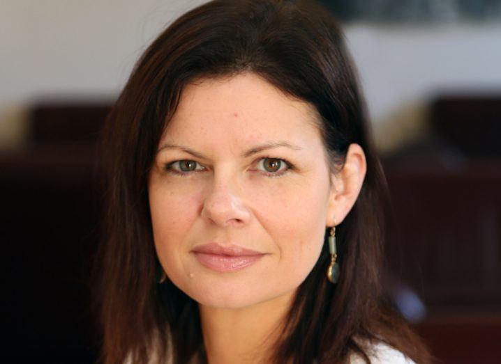 A close-up headshot of a woman with short brown hair smiling at the camera. She is Prof Christine Loscher.