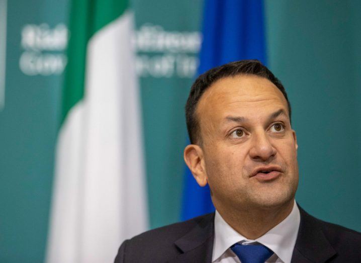 Leo Varadkar pictured at an Irish Government briefing with the Ireland and EU flags behind him.