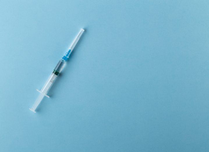 Syringe on a blue background.