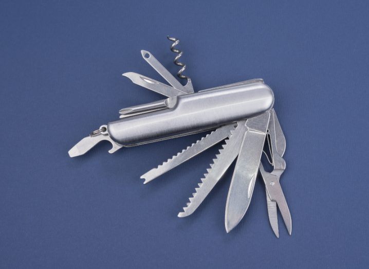 A multi-purpose pocketknife is shown. It is a silver steel and designed in the form of a Swiss Army knife.