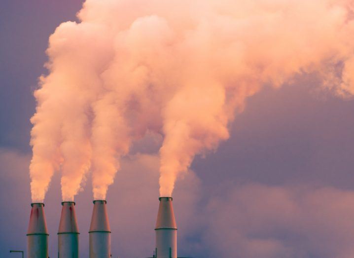 Smoke billowing from the chimneys of an energy station, polluting the sky.