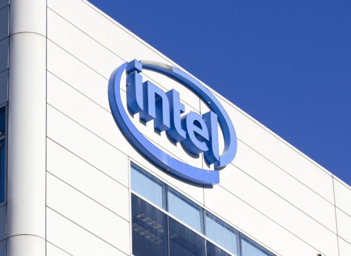 Blue Intel logo on its white-coloured headquarters in Santa Clara, California, with a blue sky above it.