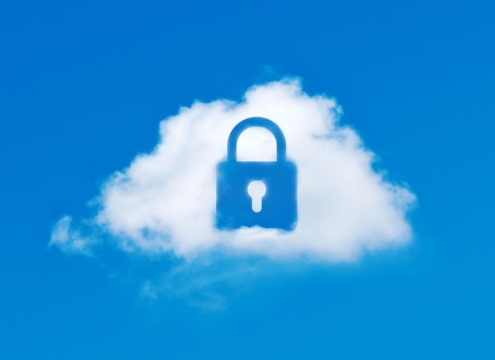 Image of cloud with a lock-shaped hole in it in front of a blue sky background.