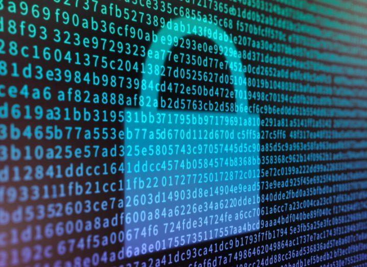 A image of a padlock is on a screen, surrounded by encrypted data code.