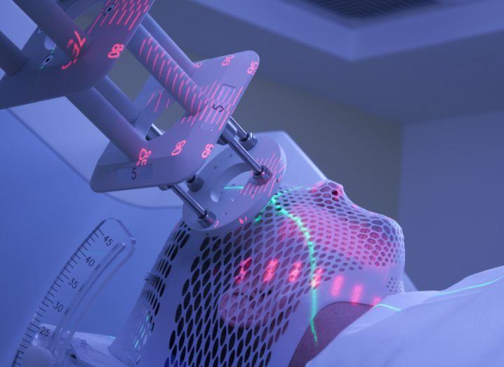 Person receiving laser treatment in a radiotherapy room.