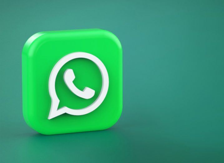 A large green WhatsApp app logo sits against a dark green background.
