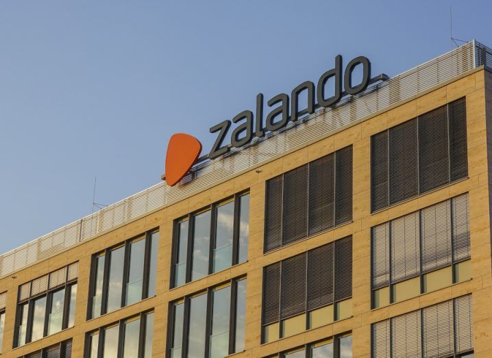 An office block against a blue sky, with the Zalando logo on top.