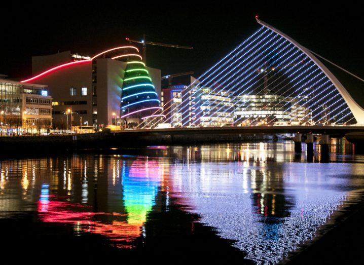 View of Dublin city at night, with lights shining from the Samuel Beckett Bridge and the Convention Centre.