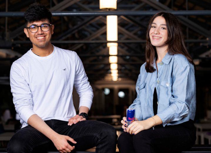 Harsh Chandra and Clara Fargas, competitors at Red Bull Basement Global Final, sitting in chairs sipping Red Bull.