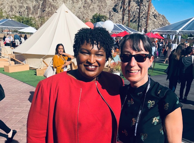 Stacy Abrams and Ann O'Dea pictured outside a large tent at the TEDWomen festival in California.