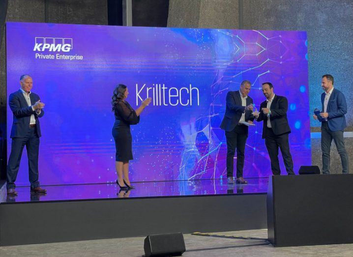 Krilltech founder and CEO Diego Stone on stage at Web Summit receiving an award from four other people.