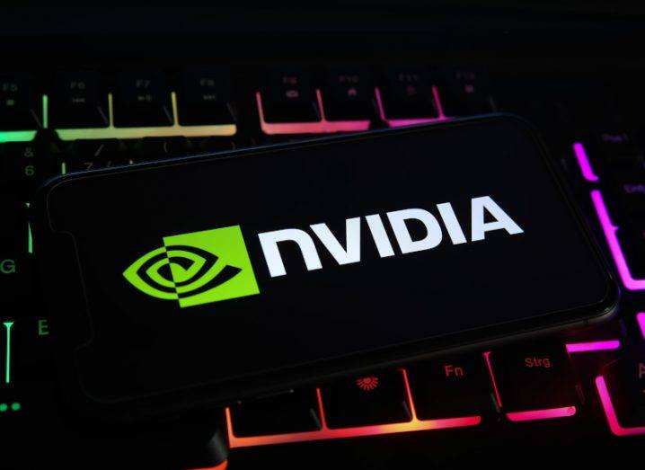 Smartphone with Nvidia logo on it, placed on a keyboard with neon-coloured backlight.