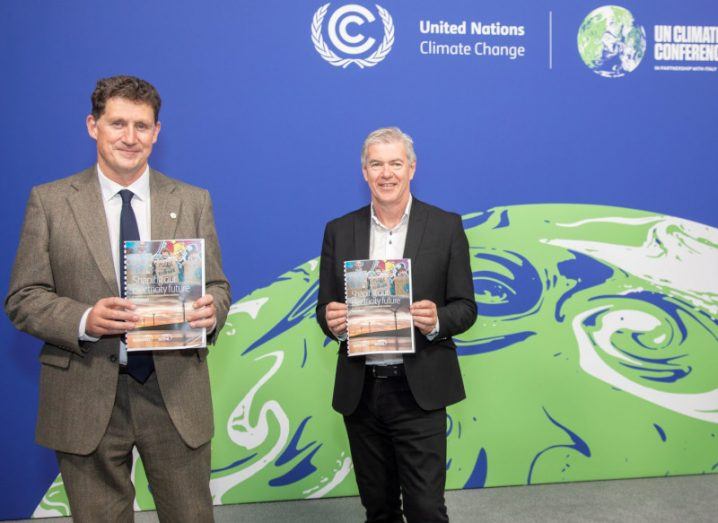 Minister Eamon Ryan and EirGrid CEO Mark Foley holding copies of the plan at COP26 in Glasgow.