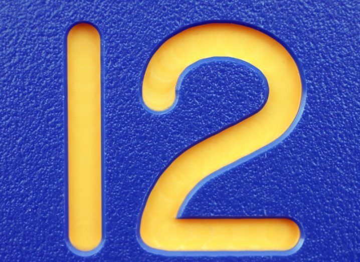 The number 12 in yellow against a blue background.