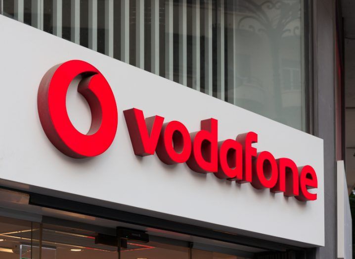 A close-up of the Vodafone logo on the front of an office building.