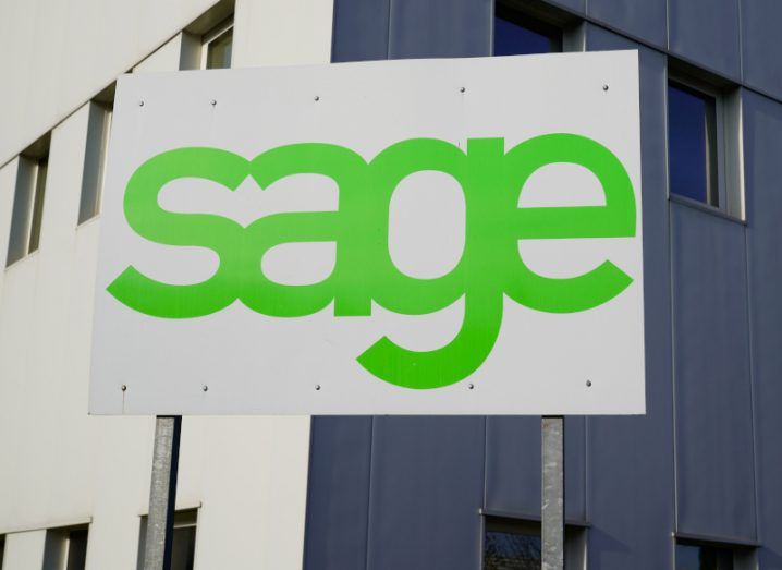 Sage logo in green letters on a white sign outside a building front.
