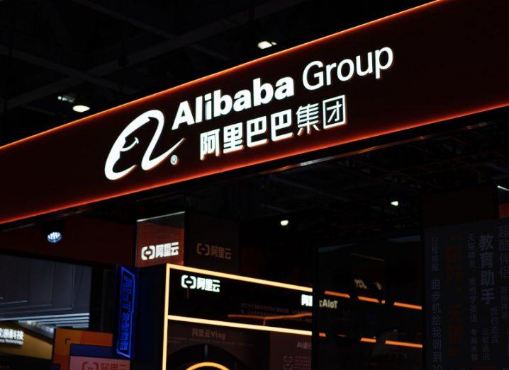 Alibaba store front pictured at night with Chinese characters and English lettering.