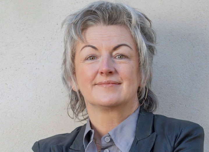 Headshot of professor Claire Connollly with a grey wall background.