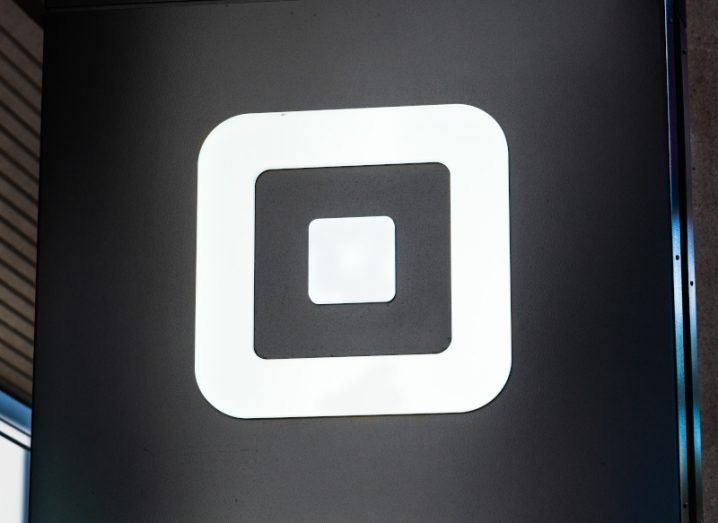 A white Square logo on a black sign.