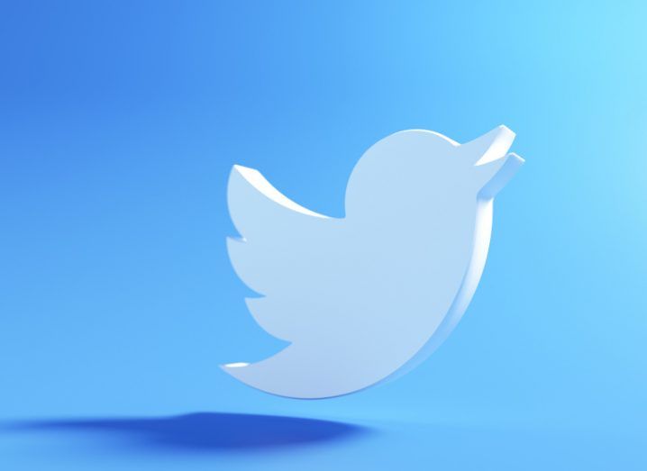 Twitter logo of a white bird floating in a blue background.