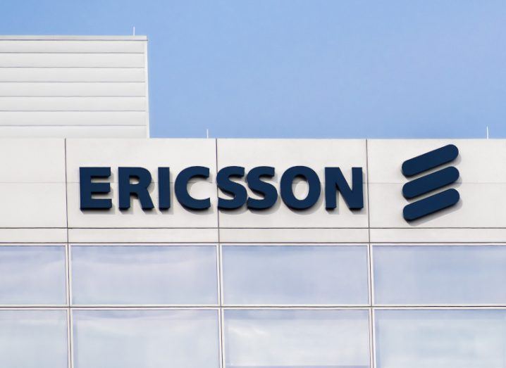 Ericsson name and logo on the top of a grey building.