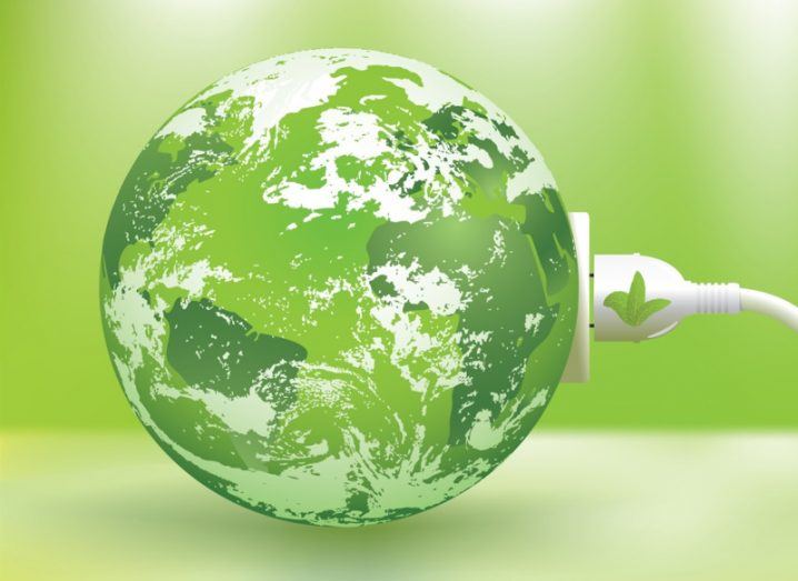 A globe of planet earth coloured green with a plug connected to it, with a green background.